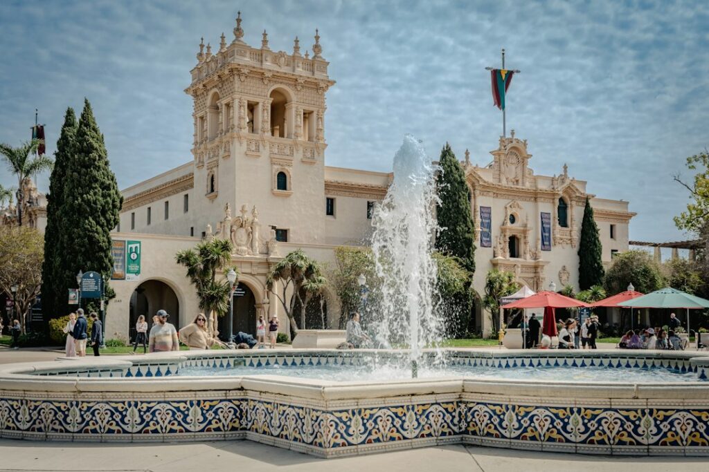 Architecture and grounds in Balboa Park, San Diego. Photo Murali Raju / Unsplash; illustrative county guide cover.