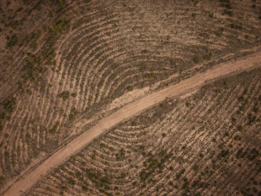 Aerial view of arid terrain by Ahmet Yüksek / Unsplash. Illustrative; not an assessor parcel map or a California land survey.