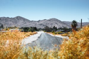 Bowman Road desert landscape photograph by Brian Wangenheim / Unsplash; illustrative, not a verified city building-permit office or specific Ridgecrest lot.
