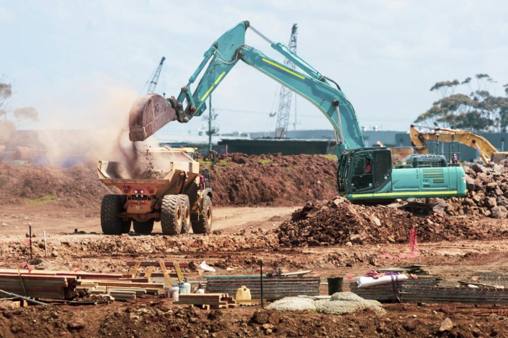 Illustrative earthmoving construction site by Troy Mortier / Unsplash; not a specific California permitted grading project.
