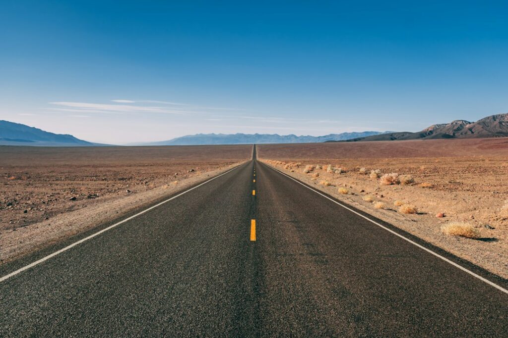 Desert highway. Photograph by Peter Mizsak / Unsplash; illustrative only, not an October 19, 2026 event photograph.