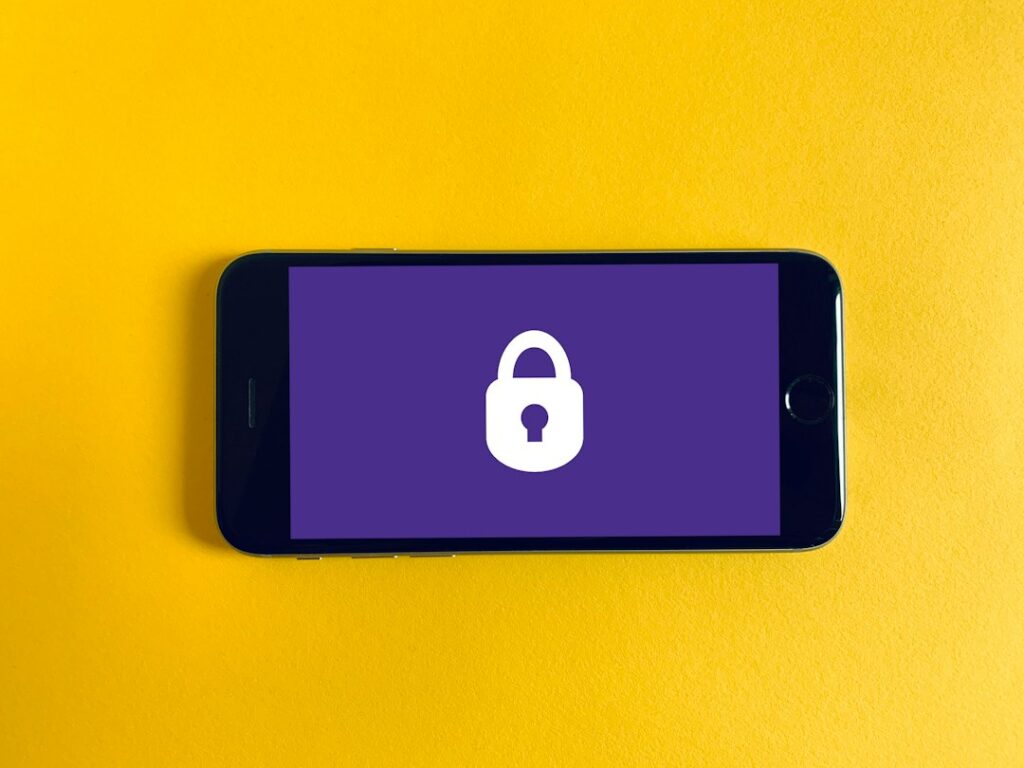 Smartphone beside a padlock, illustrating personal data privacy