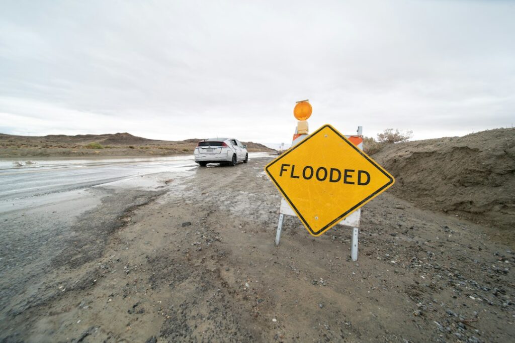Flood warning sign. Photograph by Brian Wangenheim / Unsplash; illustrative only, not an October 19, 2026 event photograph.