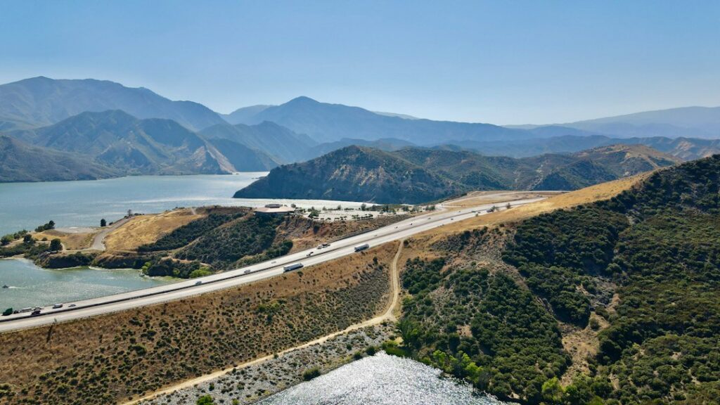 Illustrative Southern California reservoir panorama, not Nacimiento Dam or its South Access Road 2026 repair work