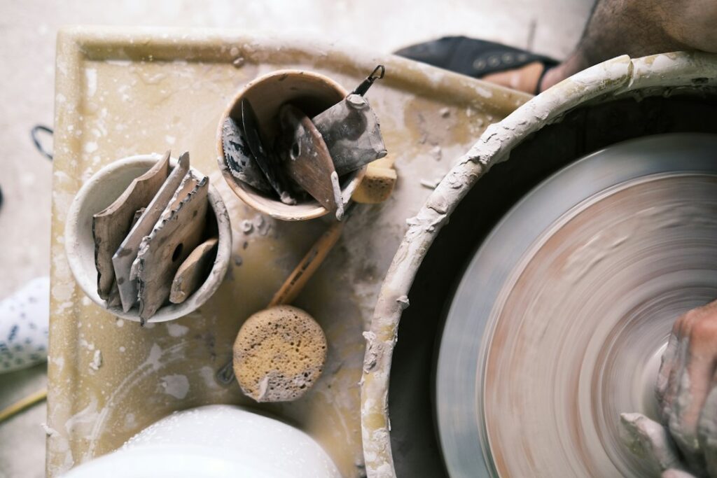 Illustrative hands shaping clay; not artwork by Becky Olvera Schultz or a photograph of the Seaside exhibition