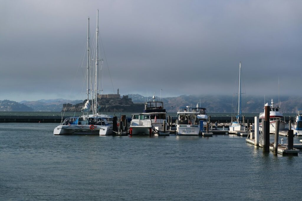 Illustrative photo of fishing boats at a dock, not a photograph of Moss Landing Harbor