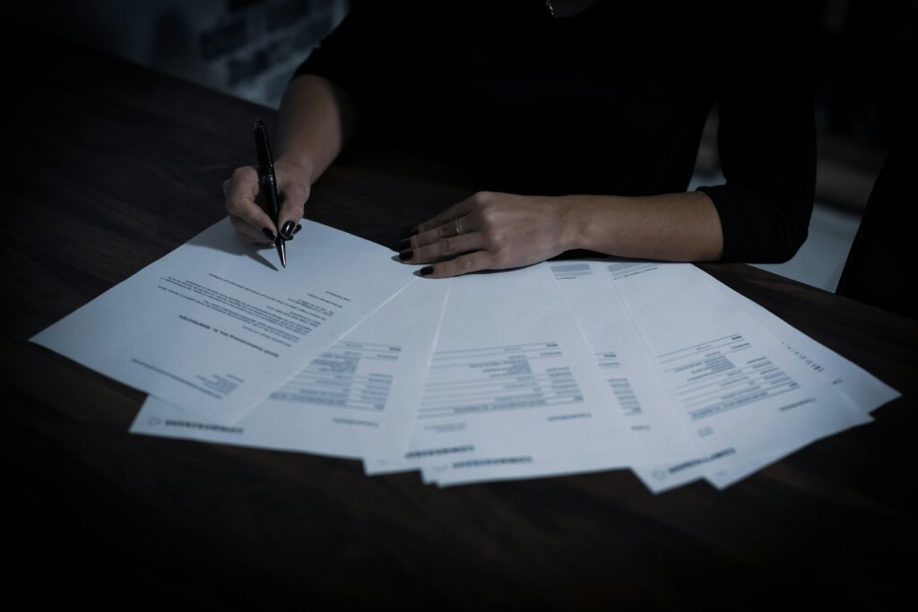 Person reviewing and signing documents; illustrative, not a Los Angeles County agenda