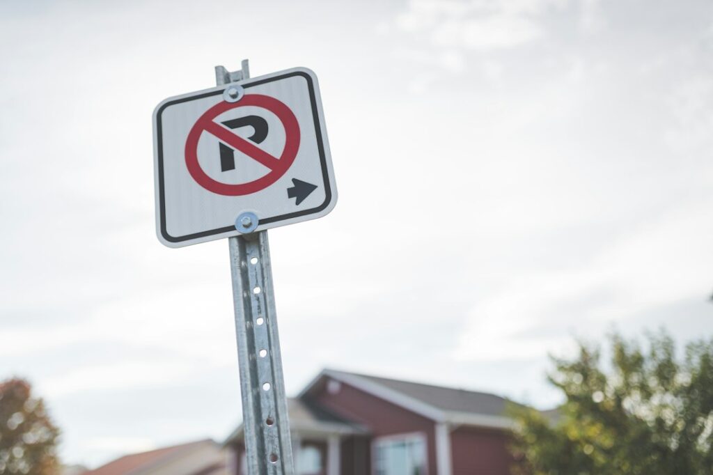 Illustrative no parking sign outside a house, not the actual signed Rogge Road or Rosehart Way segments