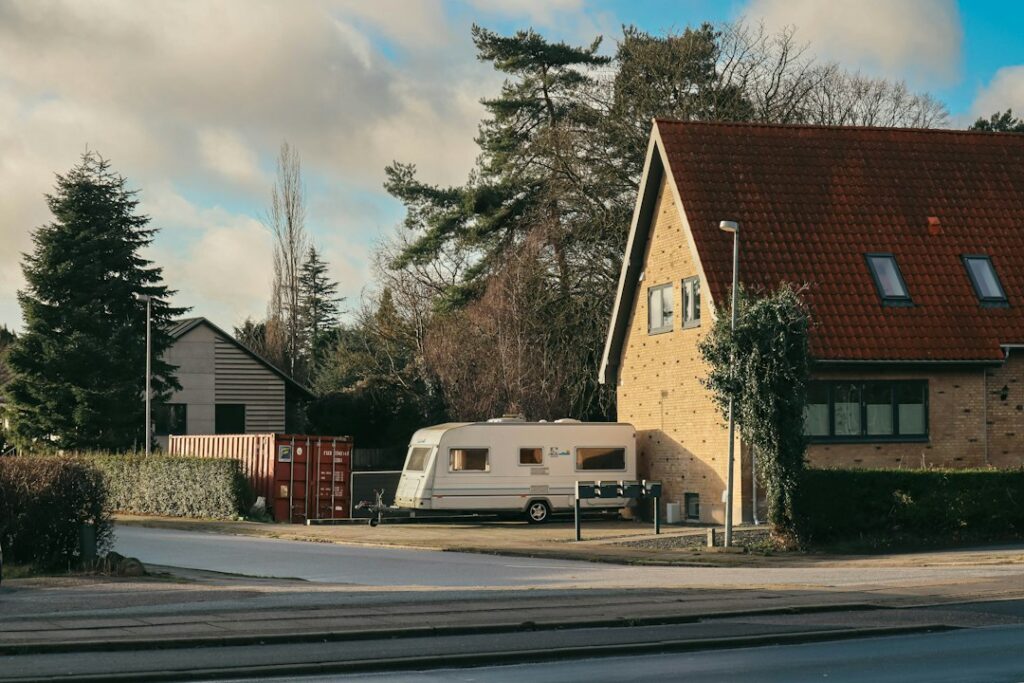 Illustrative recreational vehicle beside a house; not a Greenfield property