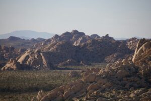 Illustrative rocky desert landscape photographed by Abhi Dasari / Unsplash. Not the St. Elmo Mine claims, Red Mountain drilling location, or any documented new mining activity.