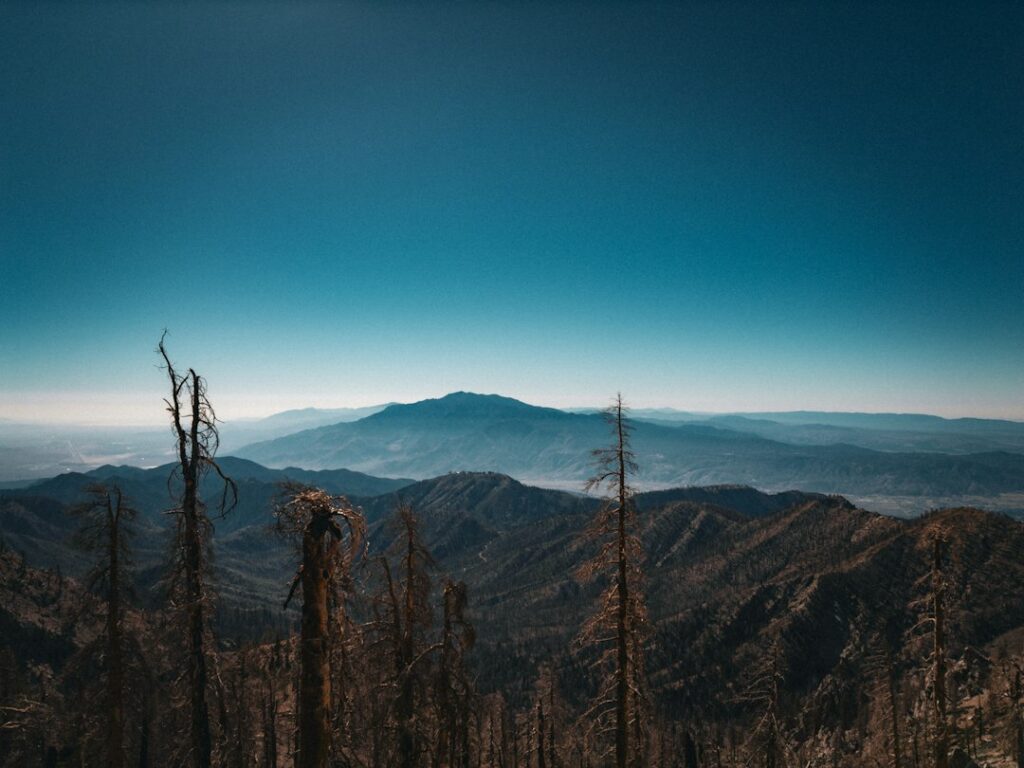 Mountain landscape photograph by Logan Voss / Unsplash. Illustrative; not a CAL FIRE hazard map, actual fire, or assessment of a parcel.