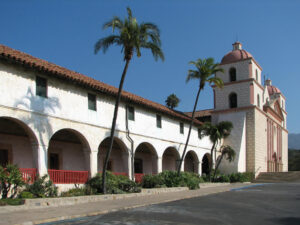 Historic Old Mission Santa Barbara with its two bell towers, arcades and palm trees in Santa Barbara, California