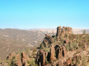 Rock formations in a dry mountainous landscape; illustrative photo of Pinnacles visitor guidance, not a live trail or parking report