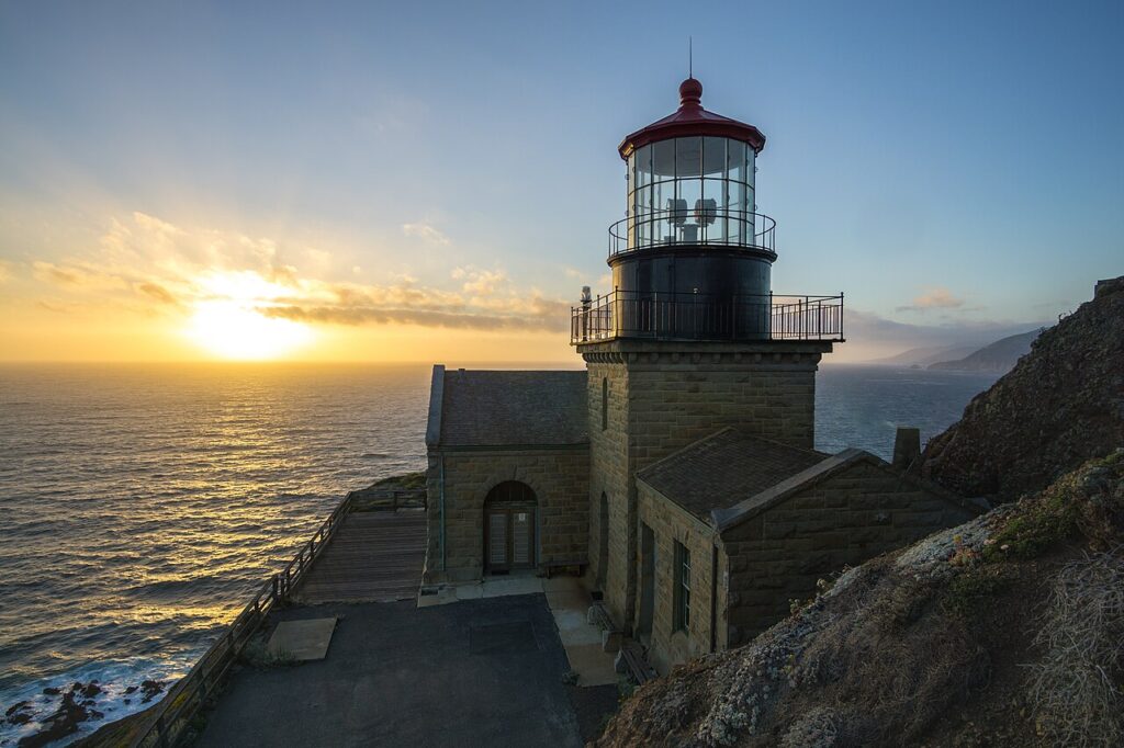 Historic Point Sur Lighthouse above the Pacific Ocean at sunset, photographed in 2018