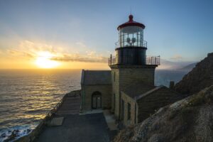 Historic Point Sur Lighthouse above the Pacific Ocean at sunset, photographed in 2018