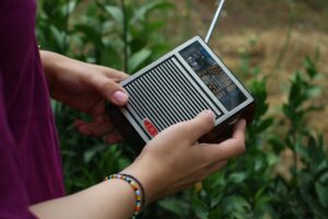 Illustrative person holding a portable radio by Israa Ali / Unsplash; not an official Red Mountain emergency incident.