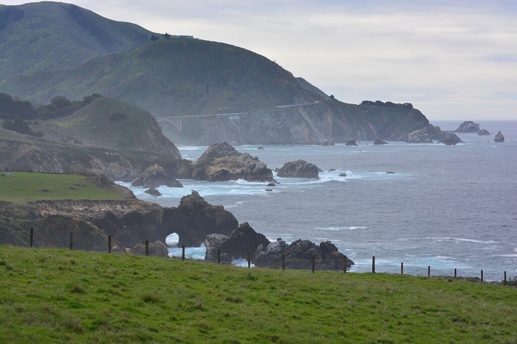 Rocky Creek Bridge and coastal natural arch seen from Notleys Landing Vista Point, photographed March 2025
