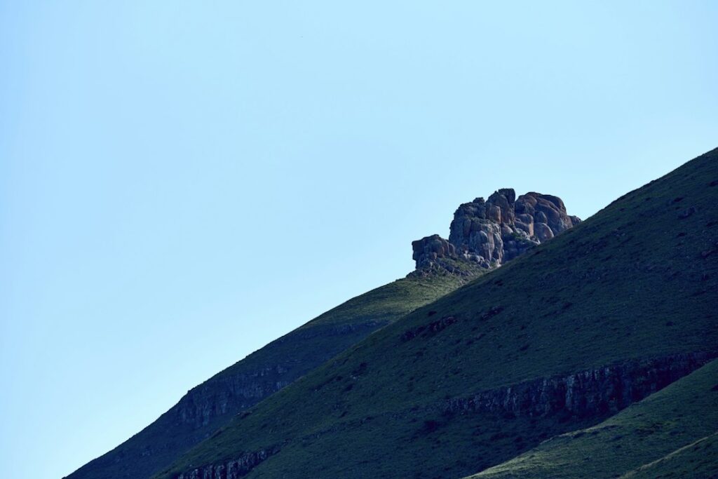 Illustrative rocky hillside landscape by Wolfgang Hasselmann / Unsplash; not a documented California landslide or geotechnical site assessment.