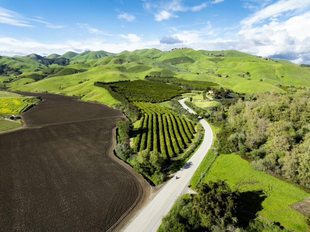 Illustrative rural valley landscape by Jeremy Bishop / Unsplash; not a verified Williamson Act contracted parcel.