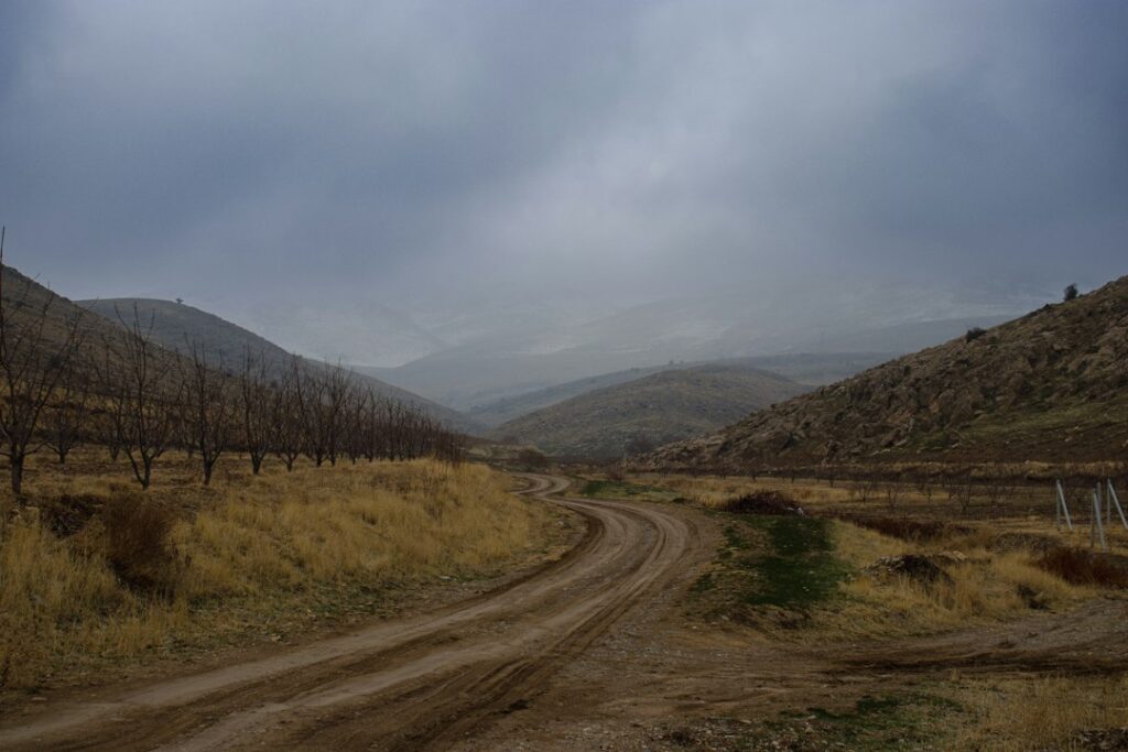 Illustrative rural road in autumn, photographed by milad nouri dastjerd / Unsplash; not a verified California public road or access easement.
