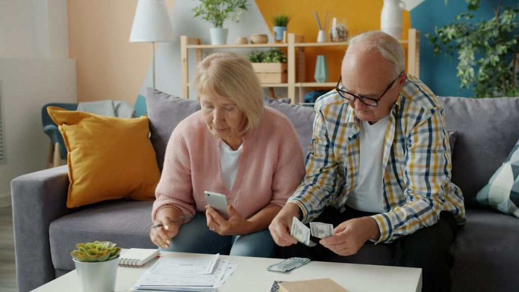 Illustrative photo of an older couple reviewing financial papers at home by Vitaly Gariev / Unsplash; not actual California program applicants.