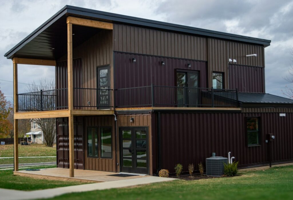 Shipping-container-style building exterior, illustrative photograph by Jubbar J. on Unsplash; not a verified permitted California project.