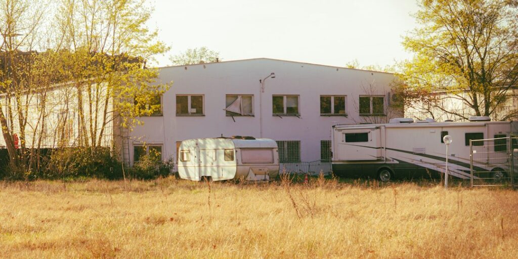 Illustrative trailers in rural setting, photo by Nicolas Görmer / Unsplash. Not a permitted California manufactured home or a depiction of an HCD inspection.