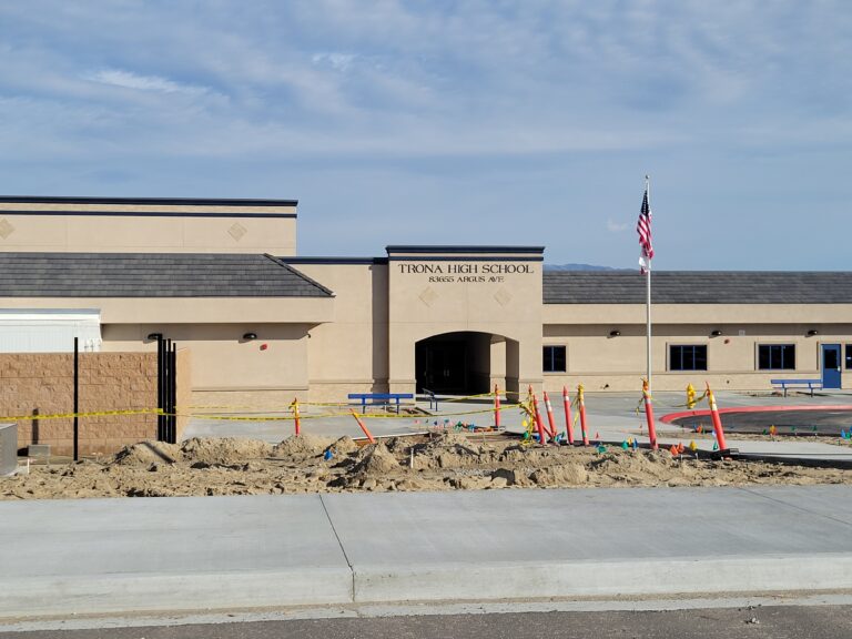 New Trona High School campus at 83655 Argus Avenue with blue trim, flagpole and new buildings; image from Trona Joint Unified School District facilities archive