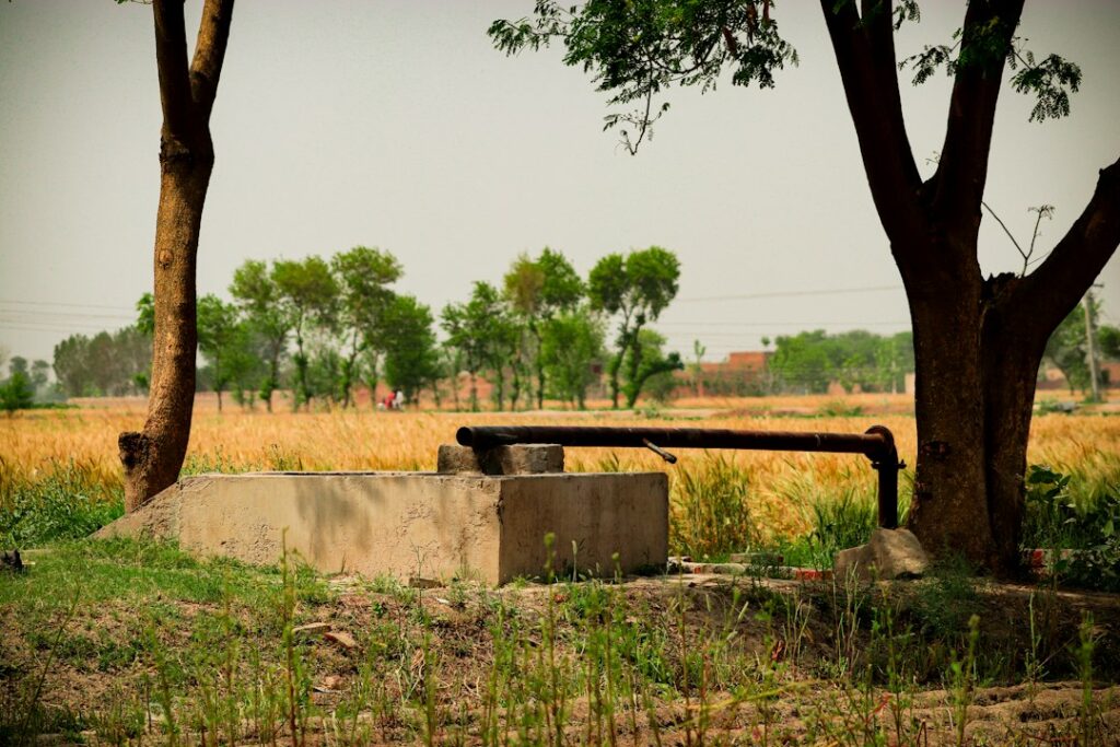 Illustrative rural water pump in a field, photo by Mirza Zubair / Unsplash. Not a California DWR well completion report or a verified well on a specific parcel.